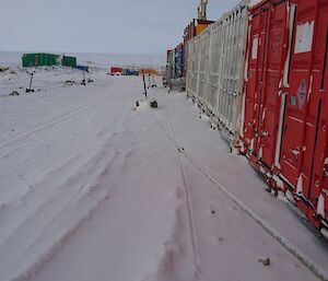 Row of shipping containers beside the road