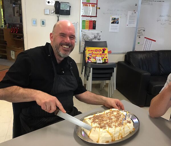 Andrew cutting a birthday cake