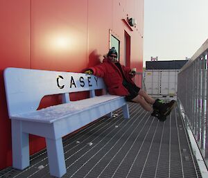 Linc sitting on the bench outside the Red Shed