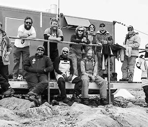 Expeditioners standing on porch of Robbos Hut