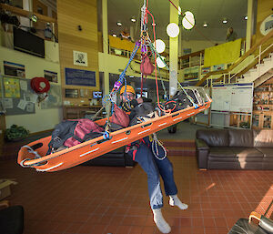 Expeditioner with stretcher hanging indoors