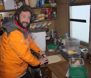 Shaun prepares a Pizza base on a bench