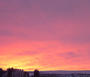 Red and pimnk sky at sunset over the gas storage rack