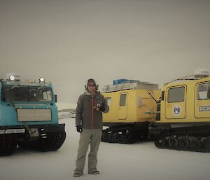 Rick standing in front of Blue and yellow Häggs holding toy dog