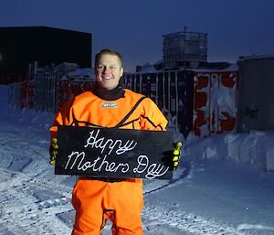 Expeditioner in dry suit with sign