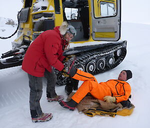 expediioner holding another expeditioners boot