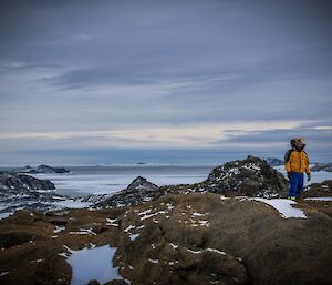 Simon inyellow jacket in front of Vanderford glacier