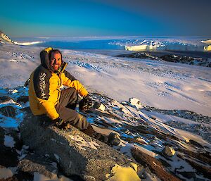 Simon at the Vanderford Glacier sitting down of a rock.