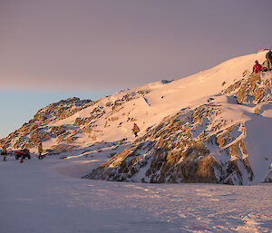 Group pf expeditioners on a hill hide at scene of training exercise.