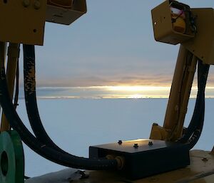 Photo of sunset with icebergs taken over the front of a machine