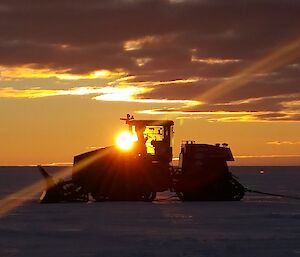 Sunrise behind machinery