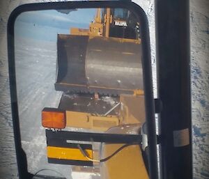 Picture of machinery through rear view mirror