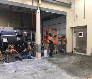 Two workers looking at a wall on construction site