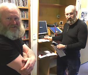 Two expeditioners looking at camera indoors