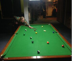 Adam taking a shot on the pool table