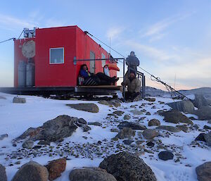 two expeditioners and inflatable toucan at Robbos hut