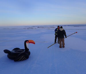 Two expeditioners and an inflatable toucan