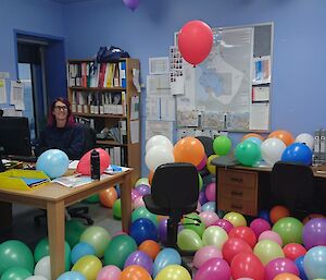 Office filled with coloured balloons