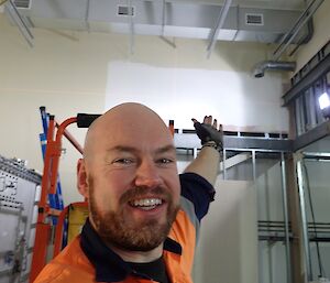 Brendan pointing at ducting on ceiling