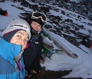 Two expeditioners standing where a melon type hut will be errected