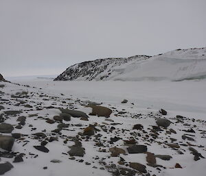 Two quad bike in distance on sea ice in channel
