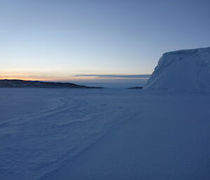 Ice cliff sea ice and island in the background.