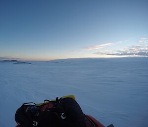 View of mainland over sea ice with rear of a quad in the frame