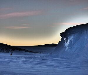 Ice cliff with two quads on left of frame.