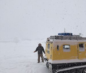 Matty and a yellow Hägglunds out in the snow.