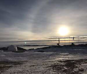 Sunrise with igloo in foreground.