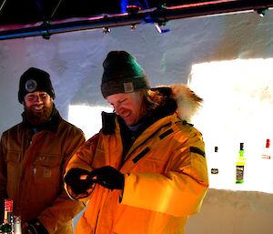 Zac and Adam standing behind an ice bar bench.