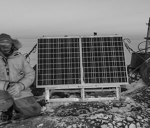 Stu beside solar panels