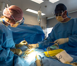 Two expeditioners in scrubs doing a practice operation.