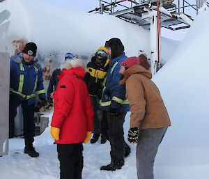 A group of expeditioners looking at the electrics panel