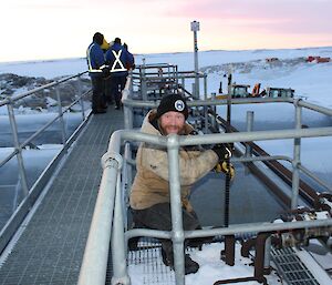 Sealy on the fuel farm measuring the fuel levels.