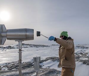 Clint changing a filter on an air monitoring project