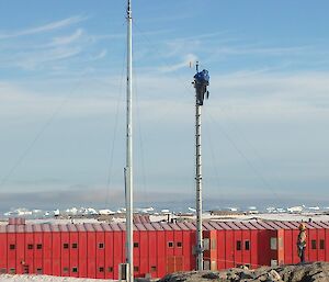 Anemometer mast with red shed in rear