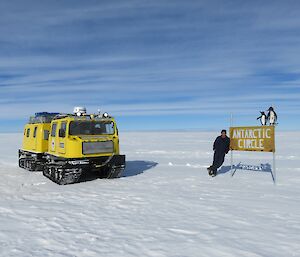 Yellow Hagg and Mark leaning on Antarctic Circle sign