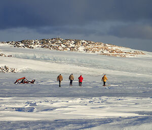 Four expeditioners in bright jackets