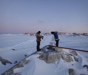 Sealy and Mick inspecting a pipe joint