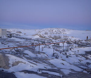 Fuel line on supports over rock and snow