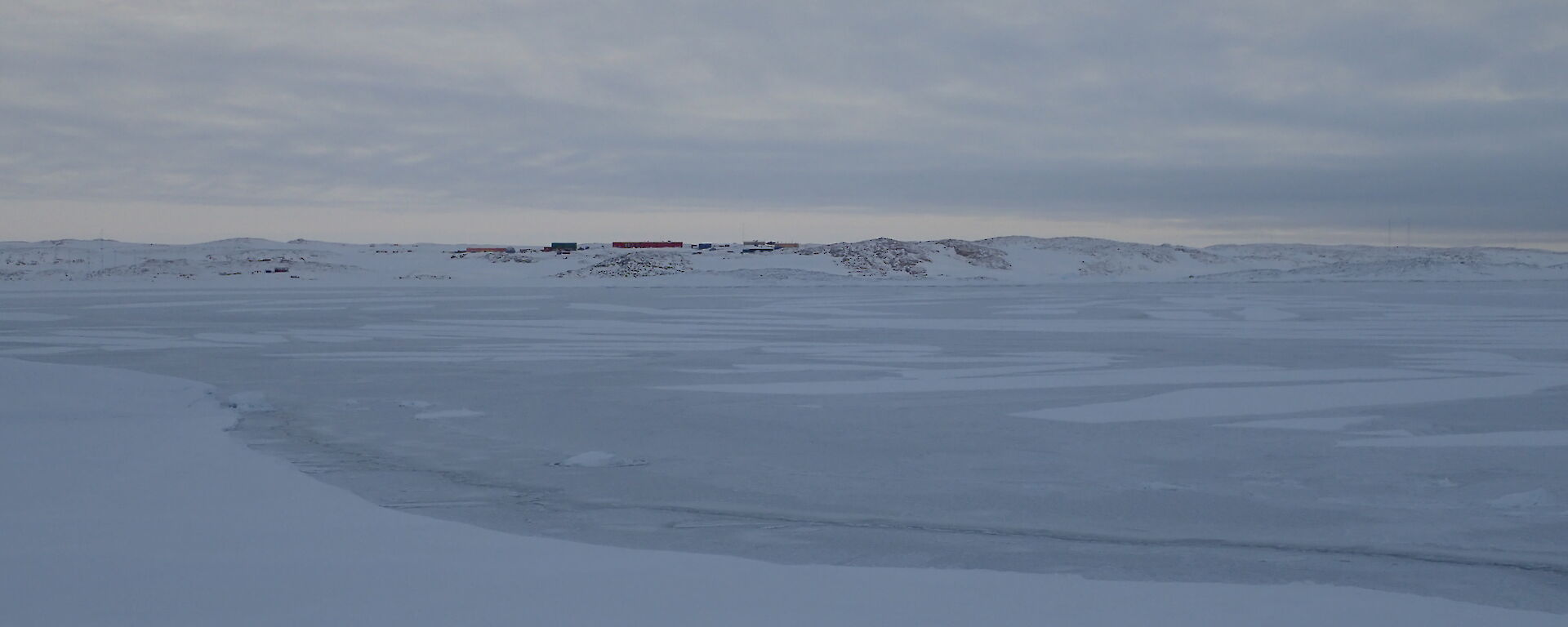 View of station across broken sea ice.