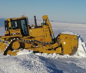 Dozer moving snow.