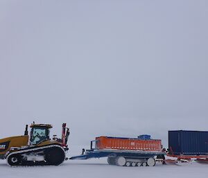 Tracked vehicle towing trailers.