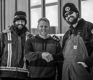 Mat and two expeditioners standing outside shaking hands.