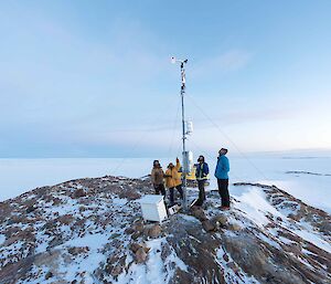 People looking up a mast