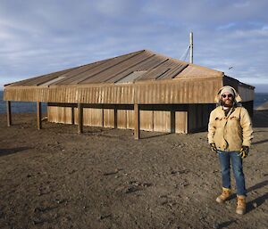 Expeditioner Ducky standing outside of Scott’s Hut.