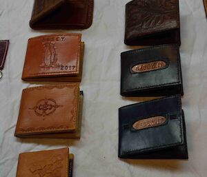 Seven hand made leather wallets.
