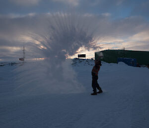 Throwing water into the air making it look like a cloud.