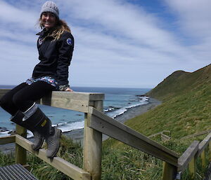 Jac sitting on a railing with clouds in sky